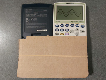 Photo of the outside of the EL-9900 held open with two pieces of cardboard and an elastic band